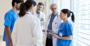 A group of providers discussing a patient's information retrieved using their EHR's HIE healthcare connection.