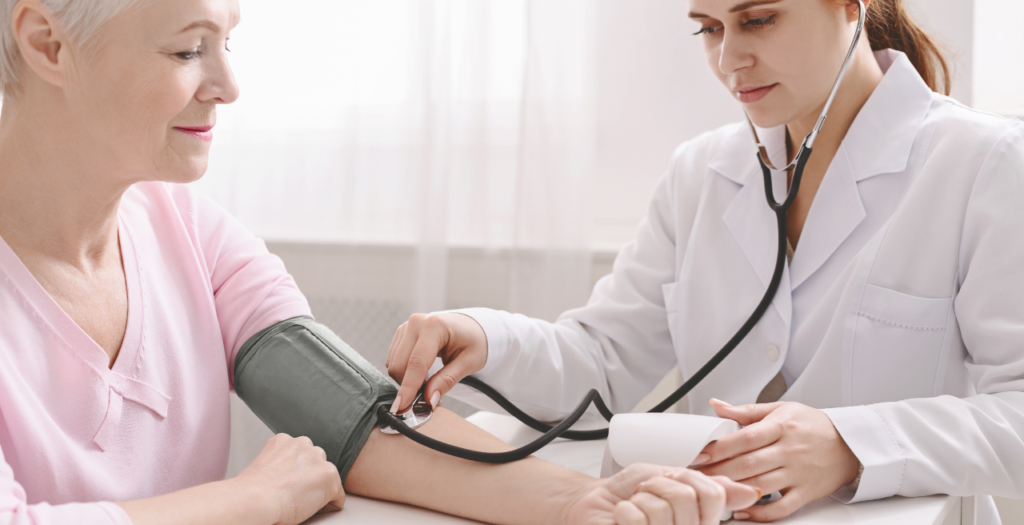 AWV blood pressure check Provider taking woman's blood pressure during her AWV