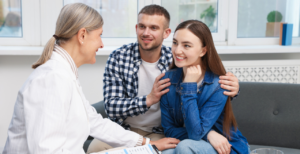 couple talking to fertility provider who chose to outsource fertility clinic billing