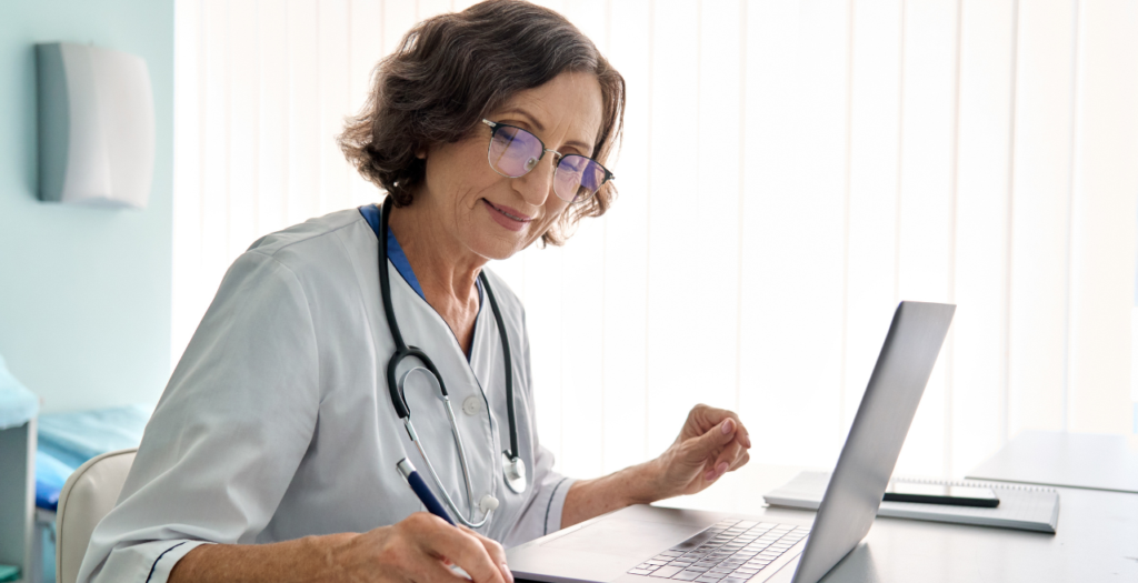 Female PA researching rural healthcare grants on laptop computer