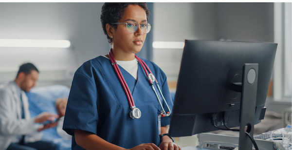 PA at computer contemplating importance of cybersecurity in healthcare