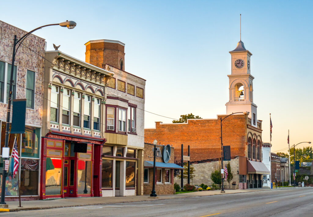 Main street of rural small town in midwest USA with storefronts and clock tower to represent the importance of rural health