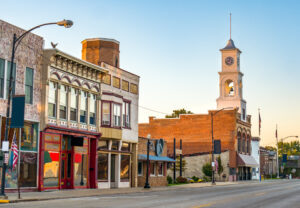 Main street of rural small town in midwest USA with storefronts and clock tower to represent the importance of rural health