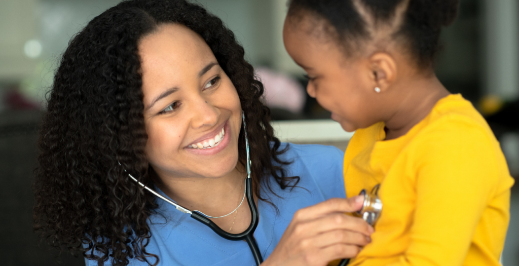 Provider examining young girl. She's focused on patient due to better medical charting tools.