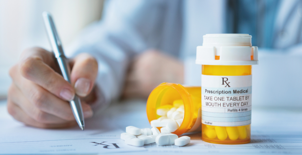 Prescription workflow represented by a doctor behind pill bottle signing old-fashioned prescription